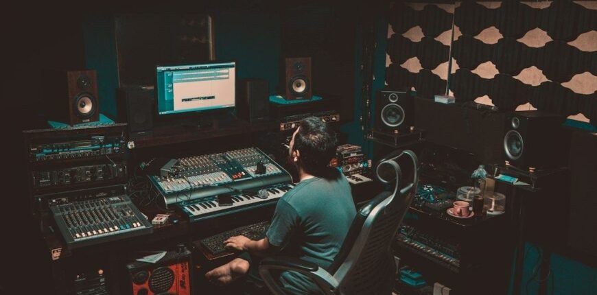 Music producer working alone at a mixing console in a studio