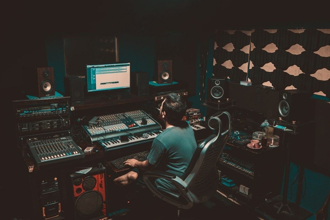 Music producer working alone at a mixing console in a studio