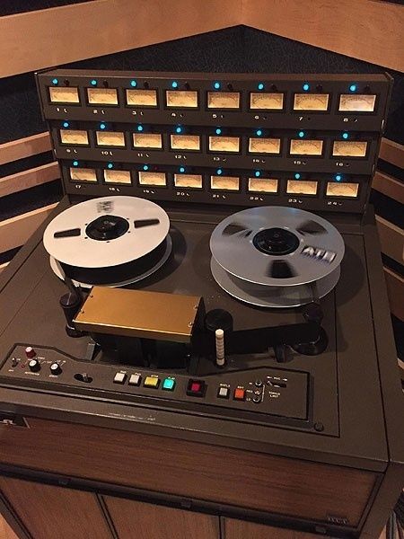 Vintage reel-to-reel tape recorder with magnetic tape reels and meters