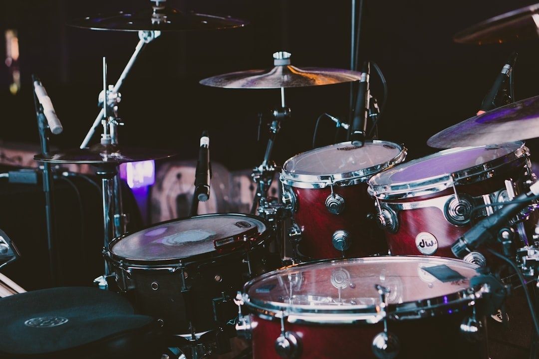 Close-up of a red drum kit set up for a live performance